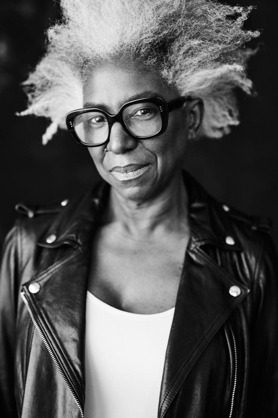 Black-and-white portrait of Andrea in a leather jacket